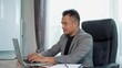 © pixs4u - Asian Businessman working with Laptop at Office Desk