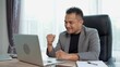 © pixs4u - Asian Businessman use laptop and smile with happiness in success