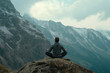 © Татьяна Евдокимова - Man meditating sitting in lotus position on a rock in a cloudy day on the Alps mountains practicing yoga