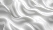 © Azadart - Soft white silk fabric draped elegantly on a smooth surface, creating gentle waves and subtle texture in natural light