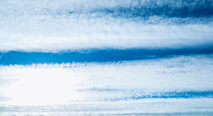 Wall Mural - dramatic blue sky background. picturesque colorful clouds lit by sunlight. vast sky landscape panora