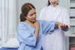 © Crystal - Medical professional palpating patient's shoulder, evaluating musculoskeletal discomfort during clinical examination in hospital setting