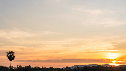 Wall Mural - sunset sky clouds over mountain in the evening with colorful orange sunlight, golden hour sky backgr