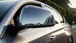 © Yudo - Close-up of a Shiny Car Side Mirror Reflecting Landscape and Sunlight