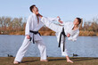 © ADDICTIVE STOCK - Karate experts practice martial arts by the serene lake