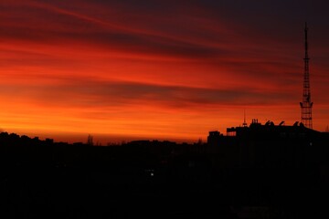 Wall Mural - picturesque view of city under beautiful sky at sunset