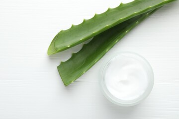 Wall Mural - cream and aloe leaves on white wooden background, flat lay
