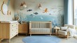 © Fakhir - a nursery with ocean-themed wallpaper behind a crib.