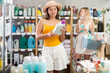 © JackF - Selective young girl holding detergent while other choosing shampoo in background during summer