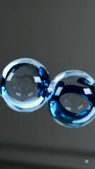 Wall Mural - glowing blue spheres in graceful motion with reflective highlights