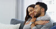 © peopleimages.com - Smile, love and hug with couple on sofa of home for bonding, support and care. Happiness, commitment and trust with man and woman in living room of apartment peace, relax and relationship romance
