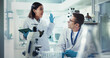 © peopleimages.com - Scientist, woman and man with high five for chemistry, success and medical research. Pathology, laboratory and assistant with tablet report for pharmaceutical or biotech experiment for breakthrough