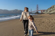 © Julija - Mother with daughter have fun at San Francisco beach, focus on woman.