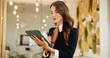 © AchillesReel25/peopleimages.com - Reading, business woman and tablet in hotel for online booking, reservation schedule or information update. Digital technology, happy worker and communication with concierge typing on hospitality app