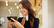 © peopleimages.com - Smile, business woman and phone in hotel for online booking, reservation schedule or information update. Digital technology, worker and internet communication with hospitality manager typing on app