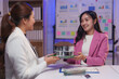 © Phimwilai - Real estate agent presenting a detailed house model to her client during an office meeting, engaging in discussions about a potential property purchase and investment opportunities