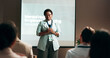 © KayExam/peopleimages.com - Seminar, speaker and woman with mic, talking and public speaking for mental health in workplace or stage. Business, presentation and employee with speech for audience, people and podium for presenter