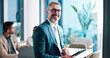 © peopleimages.com - Mature businessman, tablet and portrait in office, corporate investor and coworking. Smile, financial manager and digital technology at venture capital, private equity and executive ceo with glasses