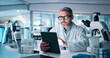 © peopleimages.com - Mature man, science and tablet at lab for medical research with DNA for human genome sequence. Person, touchscreen and clinical trial with app, investigation and review notes for pharmaceutical job