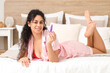 © Pixel-Shot - Young African-American woman with butt plug lying in bedroom