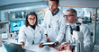 © CC/peopleimages.com - Laptop, science and tablet with people in laboratory together for breakthrough, development or results. Computer, microscope and pointing with medical research team in clinical trial for discovery