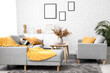 © Pixel-Shot - Interior of stylish living room with comfortable sofas, coffee table, pampas grass and yellow plaid