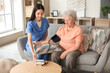 © Pixel-Shot - Young nurse measuring senior woman's blood pressure at home