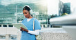 © peopleimages.com - Nurse, city and woman on tablet with headphones for education, audiobook or wellness podcast. Technology, outdoor and healthcare with medical student listening to music or study at college campus