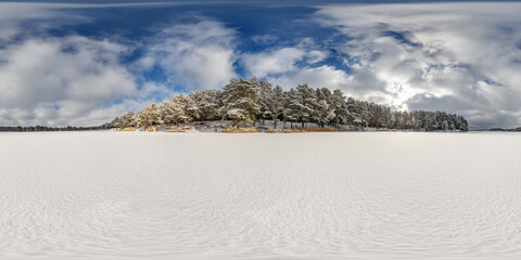 Wall Mural - winter full spherical 360 hdri panorama view on ice of frozen snow-covered lake in middle of forest in equirectangular projection. VR AR content.