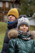 © sommersby - Winter Portrait: Two children bundled in warm coats and hats outdoor, cold weather season apparel, smiling, cheerful