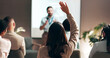© peopleimages.com - Business people, seminar and convention with audience, question and interaction for feedback or engagement. Group, speaker and back of employee with hand raised for proposal or speech at presentation