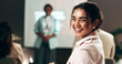 © KayExam/peopleimages.com - Woman, happy and portrait in audience at presentation, hall and learning at corporate conference. Person, smile and excited in crowd at employee seminar, confident and career training at workshop