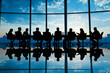 © inas - Silhouetted business meeting in modern office with panoramic city skyline view