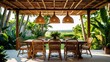 © Shadaw - A tropical outdoor dining area with a rustic wooden table and eight rattan chairs, set under a shaded pergola made of bamboo and wooden beams.