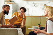 © LIGHTFIELD STUDIOS - Engaging discussions among young men at a cozy book club gathering in a modern home setting