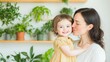 © VICHIZH - Happy mother and daughter bonding in a bright room surrounded by greenery, showcasing love, joy, and nurturing family moments in a warm, inviting atmosphere