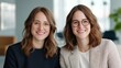 © Exnoi - Two Women with Glasses Smiling in Modern Office Setting