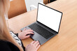 © makanna - Young white woman working on computer with blank copy space screen on table in home office. close up female businesswoman hands typing text, surfing internet on modern laptop. mock up, front view