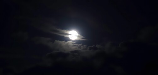Wall Mural - Serene night sky, luminous moon partially hidden by wispy clouds, weather, silver
