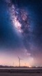 © Chaithat - Majestic Milky Way Galaxy Over Wind Turbines at Dusk Nature Landscape Tranquil Environment Wide-Angle View