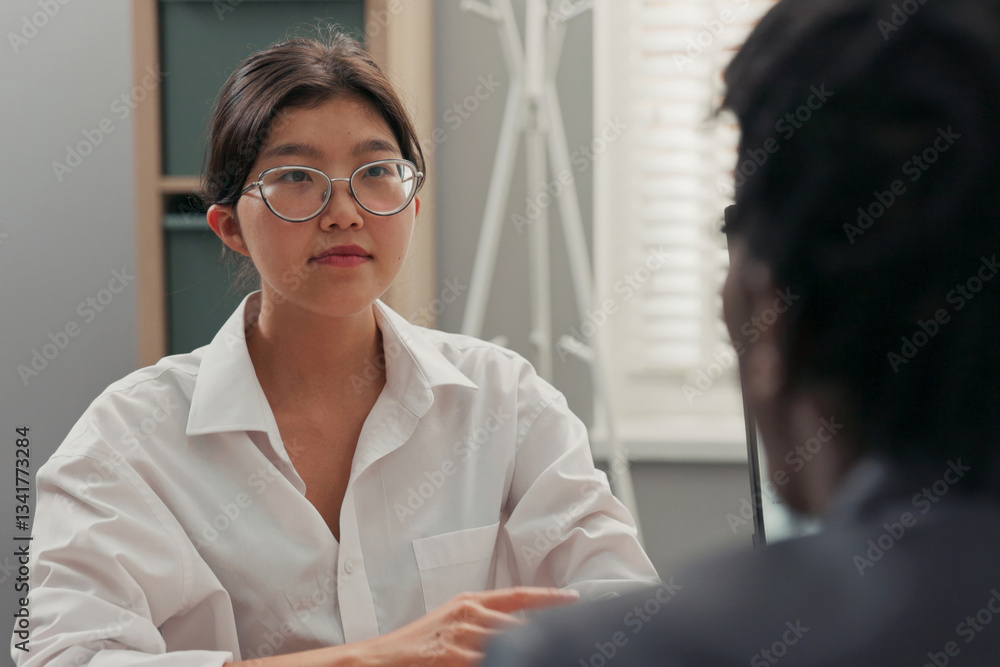 head of company, dark-skinned in suit, talks to candidate for position ...