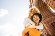 © Jordi Salas - Two happy women laughing and having fun in barcelona arc de triomf