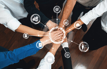 Aufkleber - A dynamic image depicting hands of diverse team members stacked together, symbolizing unity and collaboration, surrounded by business icons representing important metrics. Amity