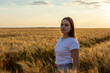 © Alexandr Macovethi - A woman in a white shirt stands gracefully in a wheat field