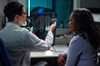 © pressmaster - Doctor showing MRI scan to African American patient in medical office discussing results and advancing healthcare professionalism within clinical environment