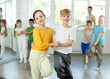 © JackF - Positive juvenile boy and girl engaged in Rock-n-Roll dance in pair together with other children and female trainer