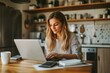 © Yevhen - Cheerful european woman working from home on marketing report at kitchen table with laptop