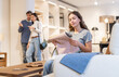 © JackF - Portrait of woman choosing upholstery fabric in the furniture salon