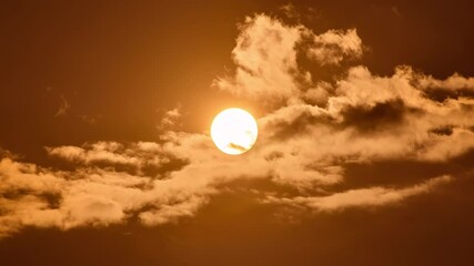 Wall Mural - timelapse of dramatic sunset with orange sky in a cloudy day.