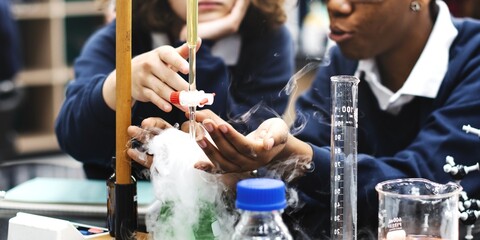 Fototapete - Students in science lab conduct experiment. Diverse students study science in school lab. Students focus on science experiment at school. Diverse students in science class conduct experiment